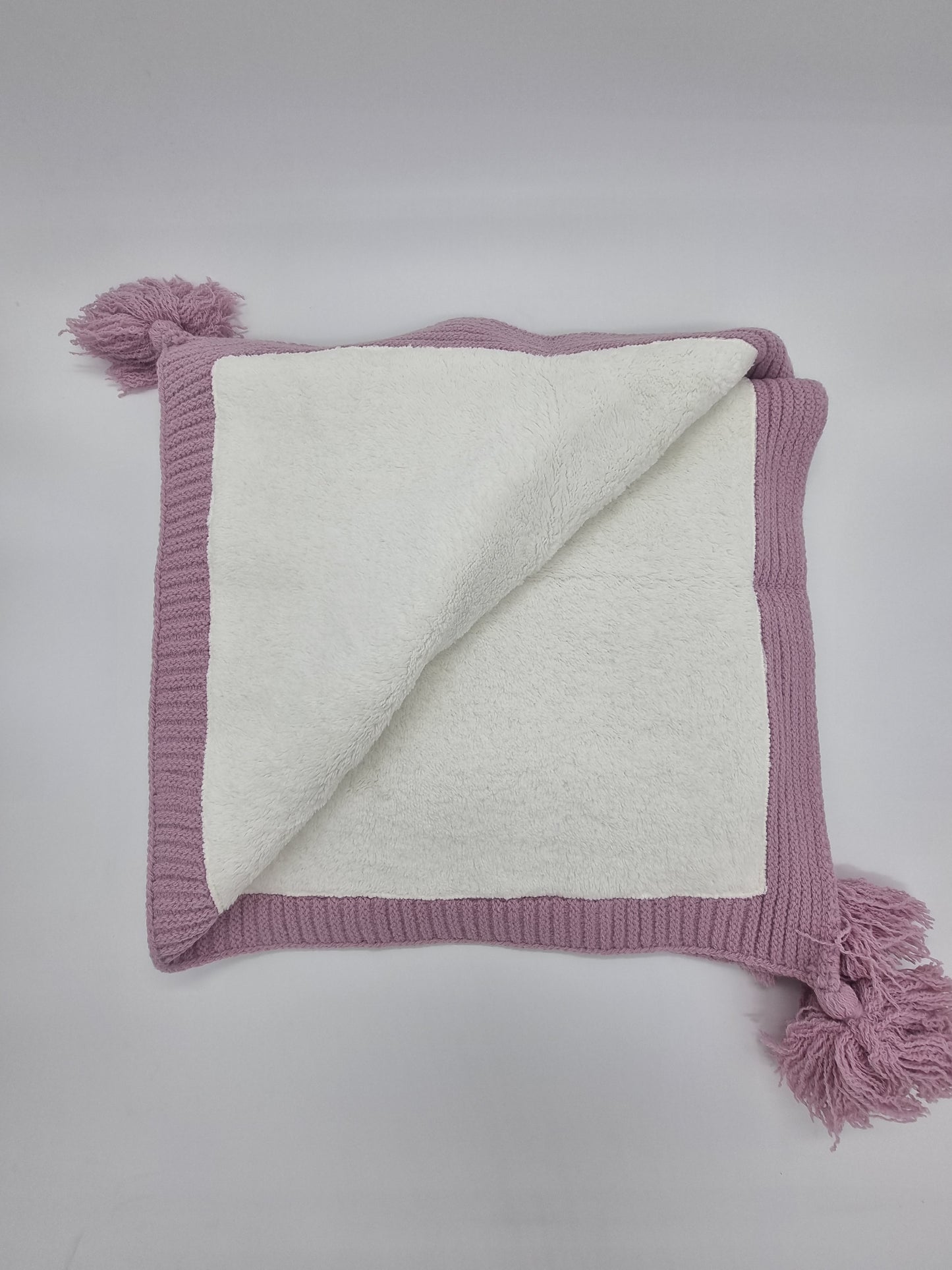 Knitted Blanket / Sherpa Fleece lining and a soft pom pom feature.